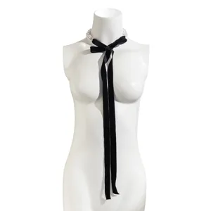 Detail view of retro black velvet bowknot choker necklace with elegant white pearls.