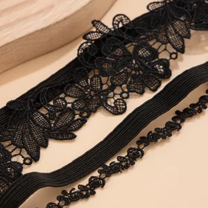 Close-up detail of the intricate black floral lace and elastic band on a Gothic garter