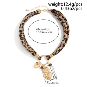 Detail view of vintage leopard print scarf necklace with gold heart pendant and measurements.