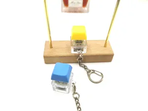 Close-up of transparent mechanical switch keycap keychain in yellow and blue