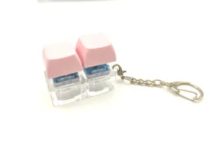 Mechanical keyboard switch keychain with pink keycaps, dual switch, portable decompression toy.