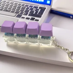 Mechanical keyboard switch fidget clicker keychain detail view with purple keycaps.