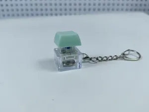 Transparent light-up mechanical keyboard switch keychain stress relief fidget toy pendant.
