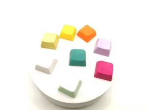 Detailed view of colorful macaron mechanical keyboard keycaps set on a white stand