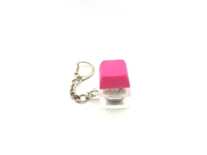 Detailed view of pink mechanical switch keychain with transparent glowing base