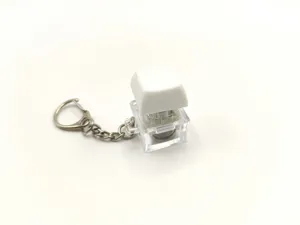 Detail view of a transparent light-up mechanical keyboard switch keychain fidget toy