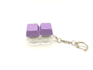 Purple fidget mechanical keyboard switch keychain toy with dual soft macaron keycaps