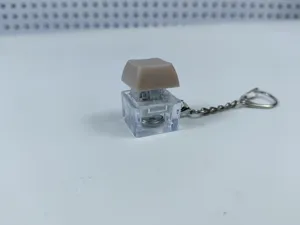 Transparent mechanical keyboard switch keychain detail, light-up stress relief fidget toy.