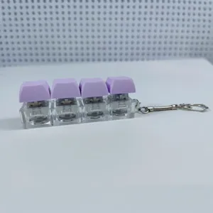Portachiavi fidget con 4 tasti meccanici viola con luce LED e base trasparente per relax
