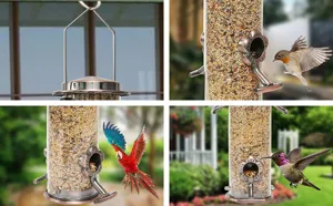 Outdoor hanging metal bird feeder with clear seed tube and decorative flower feeding ports.