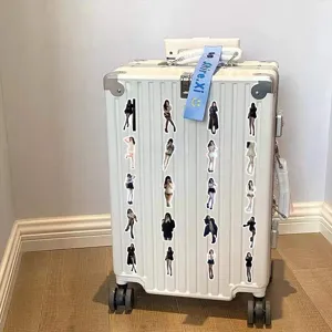 Fashionable girl stickers with various outfits displayed on a white textured suitcase