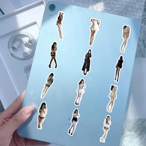 Close-up of trendy schoolgirl stickers with stockings applied to a light blue iPad