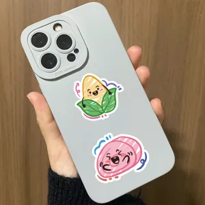 Detailed macro shot of cute cartoon food graffiti stickers on a matte gray phone case