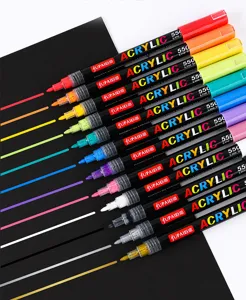 Acrylic marker pens detail showing vibrant colors and smooth writing lines on black paper surface.