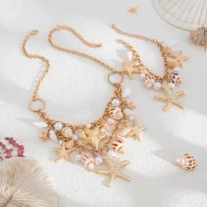 Detailed view of Bohemian gold necklace with sea shell, pearl, and starfish charms