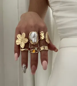 Detailansicht goldener Vintage-Ringe mit Barockperlen und floralen Mustern aus Metall