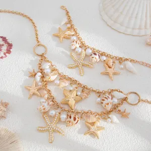 Bohemian beach necklace featuring gold starfish, sea shells, and pearls