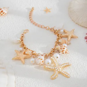 Close-up of bohemian summer beach necklace with golden starfish and pearl charms