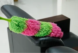 Detailed view of colorful microfiber dust duster resting on sofa, great for home daily cleaning.