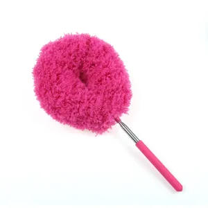 Pink extendable microfiber duster detail for household cleaning, flexible crevice cleaning tool.