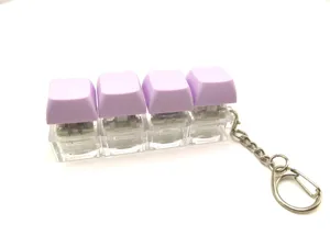 Mechanical keyboard switch fidget clicker keychain with purple keycaps for stress relief.
