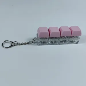 Detail shot of a 4-key mechanical keyboard switch fidget toy keychain with pink keycaps.