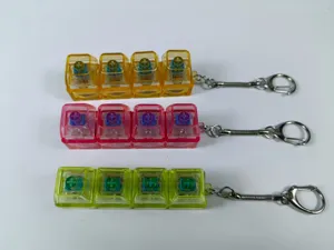 Set van drie transparante 4-toets mechanische schakelaar fidget sleutelhangers in oranje en roze