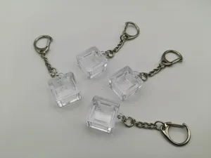 Detailed view of four transparent mechanical keyboard switch tester keychain bases
