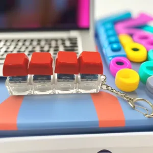 Portable mechanical keyboard switch keychain stress relief fidget toy with glowing LED light.