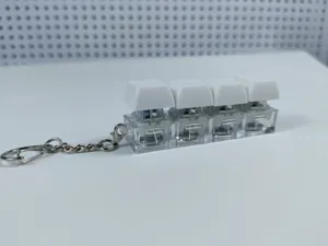 Detailed view of the 4-key mechanical keyboard switch keychain with glowing LED feature.