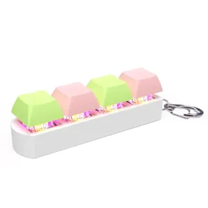 Close-up of RGB mechanical keyboard switch keychain with pink and green keys