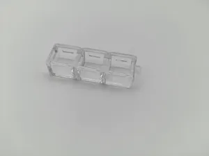 Close-up of a three-slot transparent plastic mechanical keyboard switch tester frame
