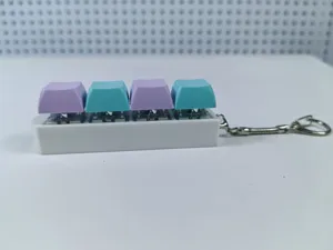 Detail of 4-key mechanical keyboard switch keychain in purple and blue colors.