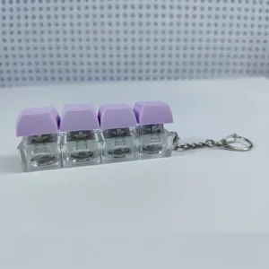 Creative 4-key mechanical keyboard switch keychain decompression toy with purple keycaps.