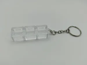 Detailed macro view of a 3-slot transparent mechanical switch tester keychain base