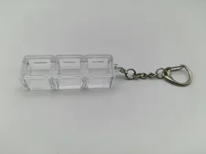 Close-up of clear 3-compartment mechanical switch tester base with durable keychain ring