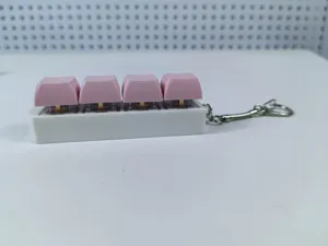 Close-up view of a pink 4-key mechanical keyboard switch fidget toy keychain for stress relief