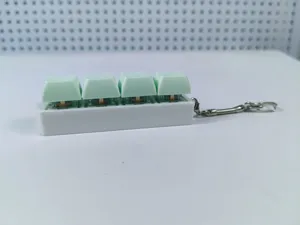 Detailed side view of a 4-key mechanical switch tester keychain for stress relief