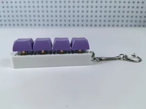 Detailed side view of a 4-key mechanical keyboard fidget toy with purple keycaps