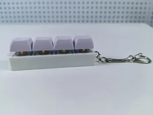Close-up of four mechanical keyboard switches with purple keycaps on a white keychain base.