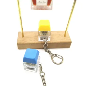 Mechanical keycap fidget toy keychain with transparent base in yellow and blue colors