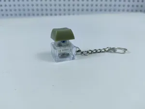 Mechanical keyboard switch fidget toy keychain with glowing LED light, portable item.