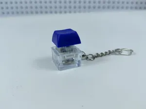 Detailed view of the clear blue mechanical keyboard switch keychain toy with LED glowing light.