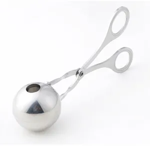 Stainless steel meatball maker detail view showing precision polished sphere mold and scissors handle.