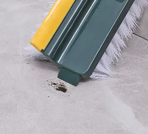 Close-up of 5-in-1 floor brush cleaning stain on tile floor
