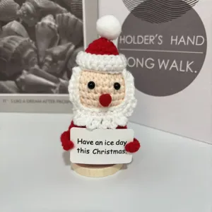 Cute handmade crochet Santa Claus figurine with wooden base and funny sign for Christmas decor.