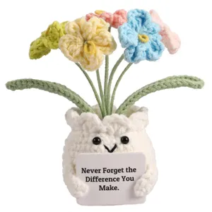 Handmade crochet potted forget-me-not flower doll with positive message card decor.