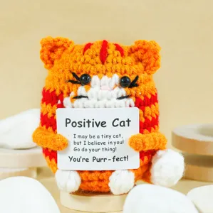 Handmade crochet positive cat doll detail view with encouraging message card and cute design.