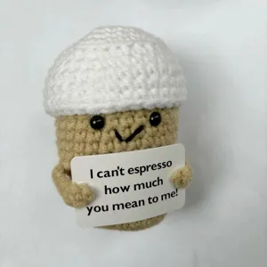 Detailed close-up shot of a cute handmade crochet coffee plush doll holding funny quote card.