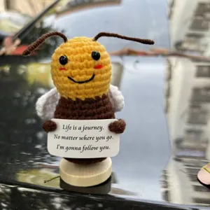 Handmade crochet cute bee figurine with inspiring sign, adorable knitted desk decor detail.